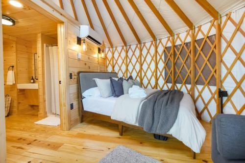 a bedroom with a bed in a yurt at Adventure Abode - Modern Yurt in Brookville