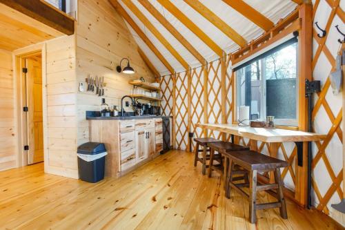 a kitchen with a table and chairs in a cabin at Starlit Haven - Modern Yurt in Brookville