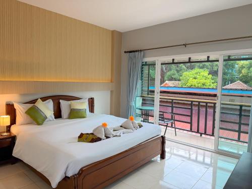 a bedroom with a bed with two birds on it at Chongkhao Resort- Phi Phi Island in Phi Phi Don