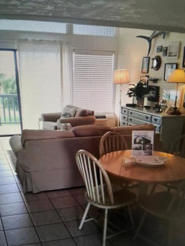 a living room with a couch and a table at Lazy Shell Condo 325 in Cedar Key