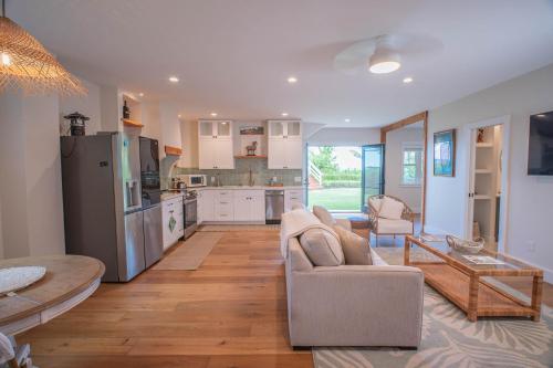 a living room with a couch and a kitchen at The Emerald House II apts in Waialua
