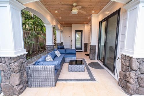 a screened in porch with a couch and a table at The Emerald House II apts in Waialua