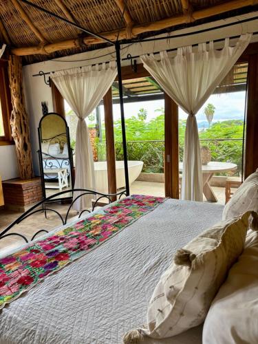 a bedroom with a bed with flowers on it at Casa Miura Hotel Boutique in Ajijic