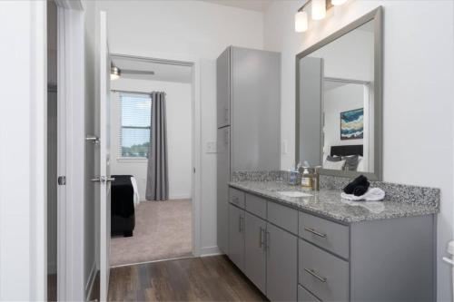 a bathroom with a sink and a mirror at 2 King Suites, Pool Near Oak Mountain in Acton