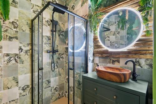 a bathroom with a wooden sink and a shower at Jungle & Sauna in Chaville