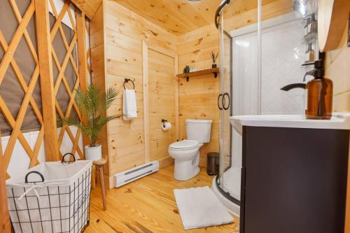 a bathroom with a toilet and a sink at Horizon Hideout - Modern Yurt in Brookville