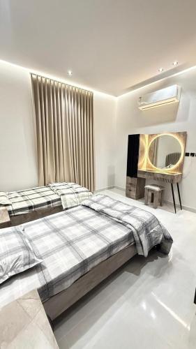 Ένα ή περισσότερα κρεβάτια σε δωμάτιο στο الجود للشقق المفروشة