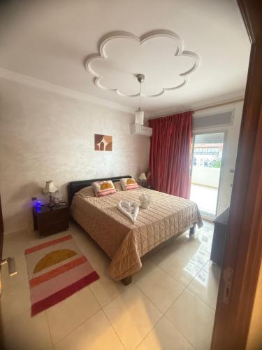 a bedroom with a bed and a chandelier at Spacious Appartment in the heart of Tangier with 2 living rooms, 2 bedrooms KING SIZE beds, 2 baths, 2 patios in Tangier