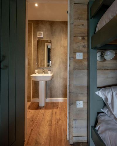 a bathroom with a sink and a mirror at Llechwedd Glamping in Blaenau-Ffestiniog