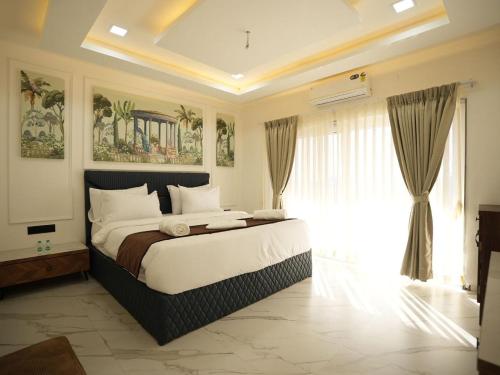 a bedroom with a large bed and a large window at The Mansion Resort And Spa in Panchgani