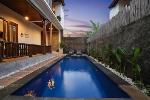 a swimming pool in the backyard of a house at Kubu Daje Villa Canggu 2BR With Private Pool in Dalung