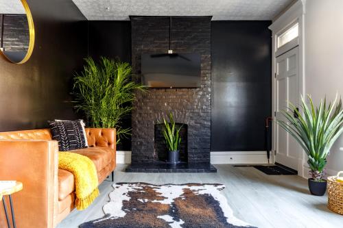 a living room with a couch and a fireplace at Short North Convention King Bed Free Parking! in Columbus