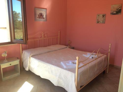 A bed or beds in a room at Agriturismo S´Aranada