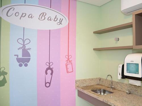 a kitchen with a copa baby sign on the wall at Olimpia Park Resort in Olímpia