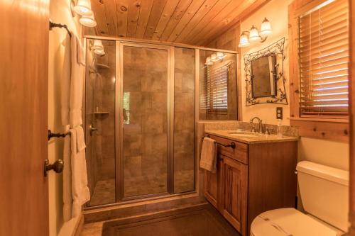a bathroom with a shower and a toilet and a sink at Almost Heaven in Sugar Grove