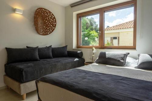 a living room with two beds and a couch at Upper View Villa, with private pool in Chania