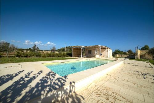a swimming pool in front of a house at Villa La Reimunda in Otranto