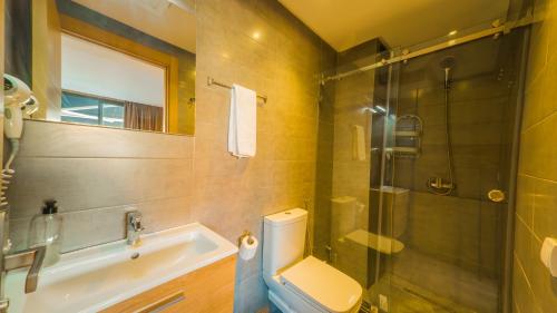 a bathroom with a toilet and a shower and a sink at Atlas-Résidence by Rent-Inn in Rabat