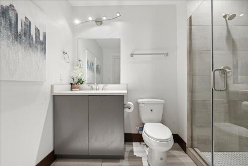 een badkamer met een toilet, een wastafel en een douche bij Historic Downtown Condo no 102 in Dallas