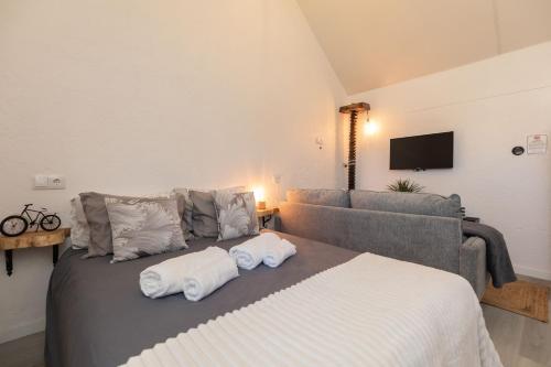 a bedroom with a bed with towels on it at Casa Serafina by Rent-a-key in Santa Maria Madalena