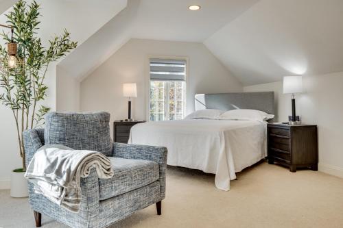 a bedroom with a large bed and a chair at Million-Dollar Mtn Views! Gilford Gilded Loon in Glendale