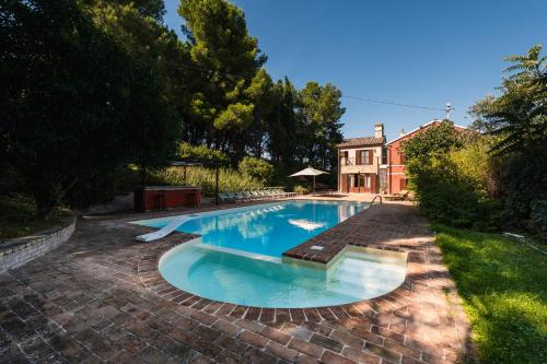 a swimming pool in the yard of a house at Villa Adele - Historic Dimora with pool & sea view in Senigallia
