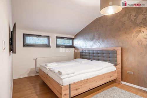 a bedroom with a large bed in a room at Apartmány Fun & Relax Dolní Morava in Dolní Morava