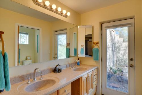 a bathroom with two sinks and two mirrors at Pool and Stunning Mtn Views! Eclectic Tucson Home in Tucson
