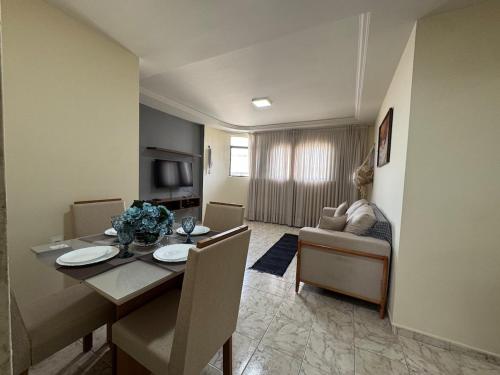 a room with a dining table and a living room at Conforto e espaço garantido no Bessa in Nossa Senhora do Livramento