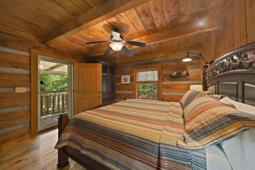 a bedroom with a bed and a ceiling fan at Natures Call in Boone