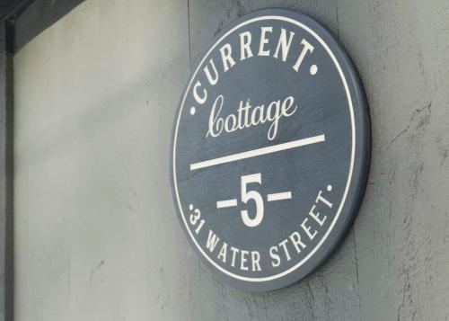 a sign on a wall that reads current lighthouse water street at Current Cottage Waterside 1 Bed 1 Ba Private Pond in Bradford