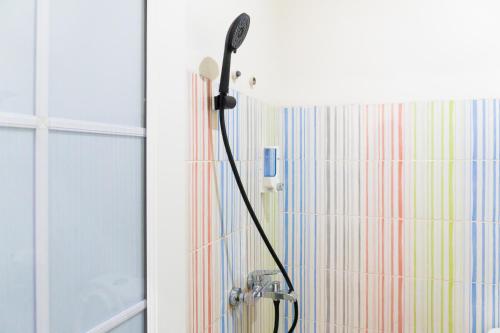 a shower with a blow dryer in a bathroom at Behomy Harita Lampung in Geruntang