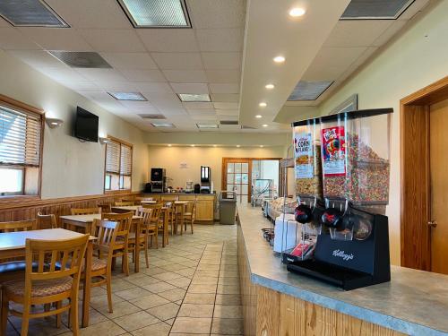 a dining room with wooden tables and chairs at Mariner Inn And Suites in Kill Devil Hills