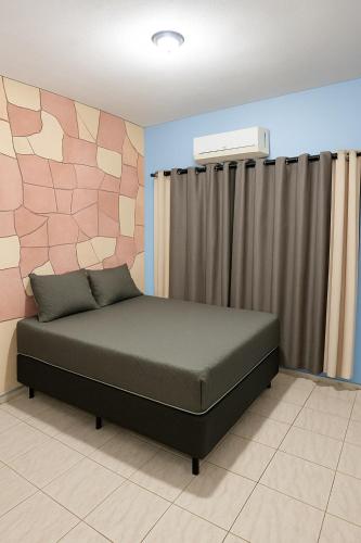 a bedroom with a bed in a room at Air conditioning, TV and free parking - Bathroom in Cuiabá