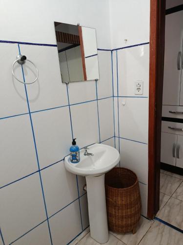 a bathroom with a sink and a mirror at Air conditioning, TV and free parking - Bathroom in Cuiabá