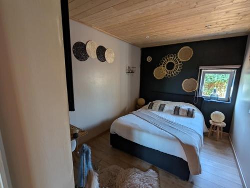 a bedroom with a bed and a window in it at Gite Chez Tof et Ninie in Houlle