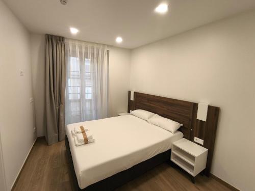 a bedroom with a bed with a cross on it at HeyWelcome Valladolid Centro in Valladolid