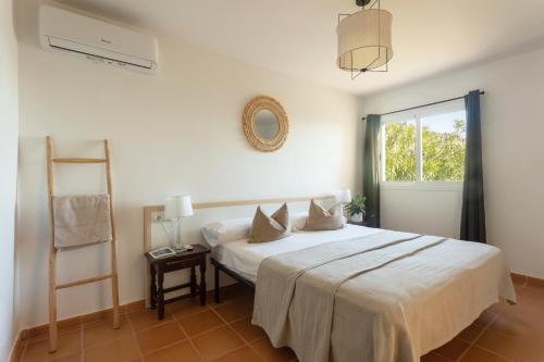 a bedroom with a bed with a ladder and a window at Casa Panorama in Illes Balears