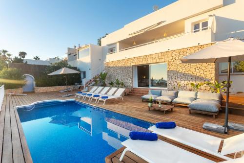a villa with a swimming pool and a house at Casa Panorama in Illes Balears