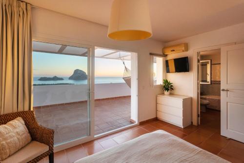 a bedroom with a view of the ocean at Casa Panorama in Illes Balears