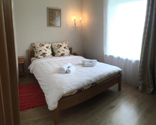 a bedroom with a bed with two towels on it at More Guesthouse in More