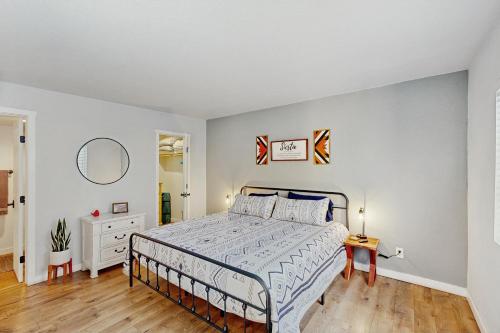 a white bedroom with a bed and a mirror at Mtn-View Condo w/ Resort Amenities in Tucson! in Tucson
