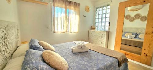 a bedroom with a blue bed with pillows on it at Urban loft Valencia playa in Puebla de Farnals