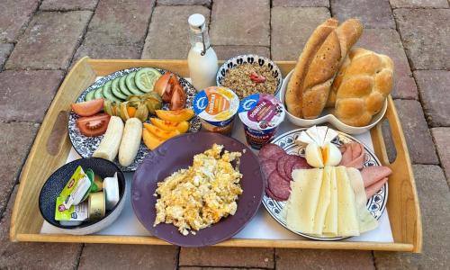 a tray of different types of food on a table at Celoročně obyvatelná maringotka Kratochvíle 