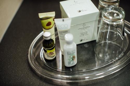 a glass table with bottles and a box on it at Hotel Schmachtendorf in Oberhausen