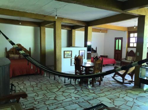 a room with a hammock in the middle of a room at Habitación espaciosa Sol in Taxco de Alarcón