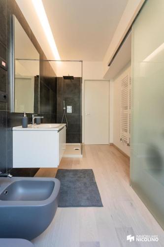 a large bathroom with a tub and a sink at CASA JACK Open Space Piazza Galimberti in Cuneo