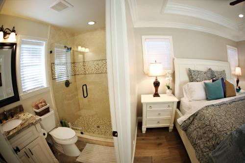 a bedroom with a shower and a bed and a bathroom at Destination #26 in Anaheim