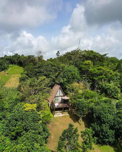an aerial view of a small house on a hill at Exclusive Huts in Gravatá