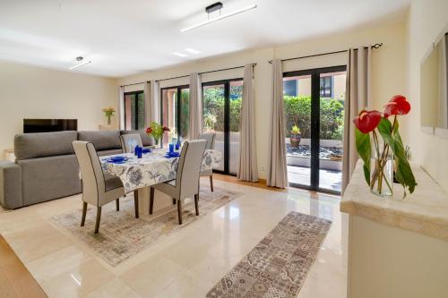 a living room with a table and chairs and a couch at Sunscape T2 in Funchal